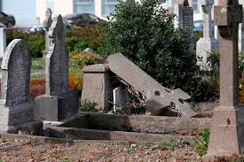 A fallen memorial element in a UK cemetery